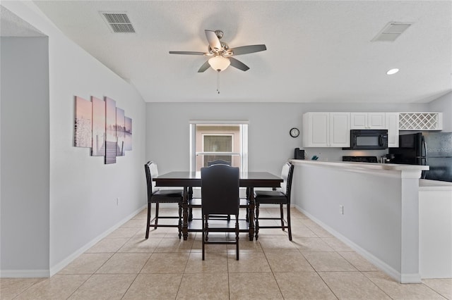 dining area with ceiling fan, a textured ceiling, and light tile patterned floors