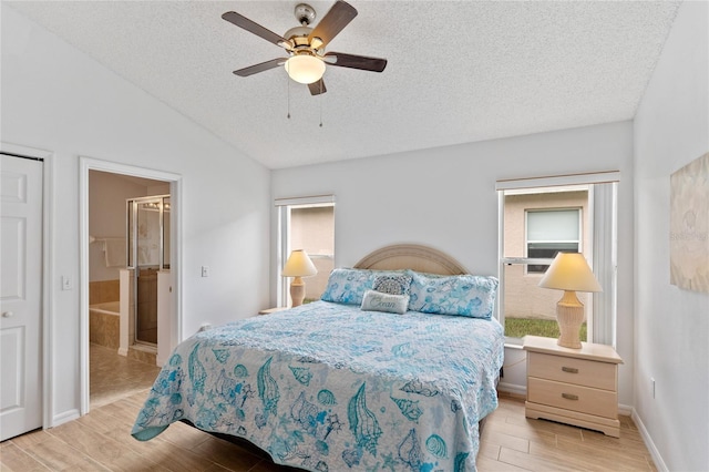 bedroom with ceiling fan, a textured ceiling, light wood-type flooring, and vaulted ceiling