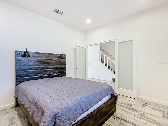 bedroom with wood-type flooring