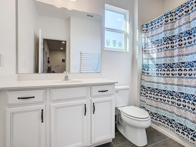 bathroom with toilet, vanity, tile patterned floors, and curtained shower