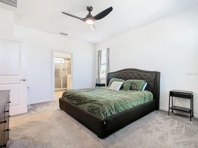 carpeted bedroom featuring ceiling fan and ensuite bath