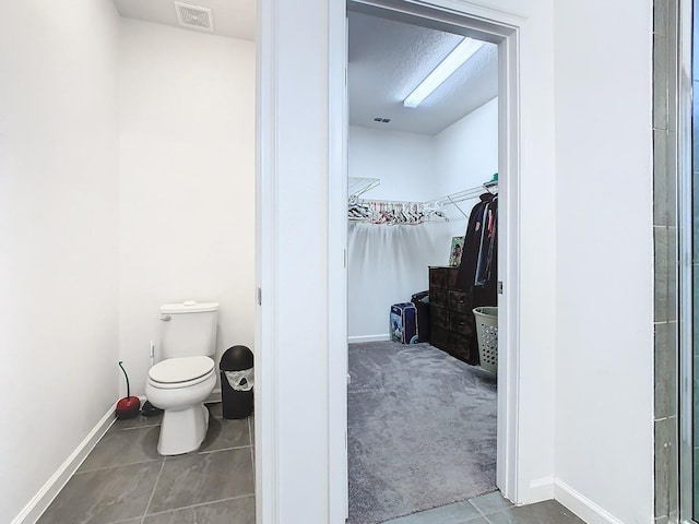 bathroom featuring tile patterned flooring and toilet