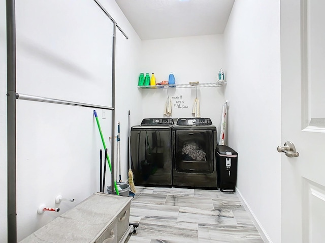 washroom with light wood-type flooring and washer and clothes dryer