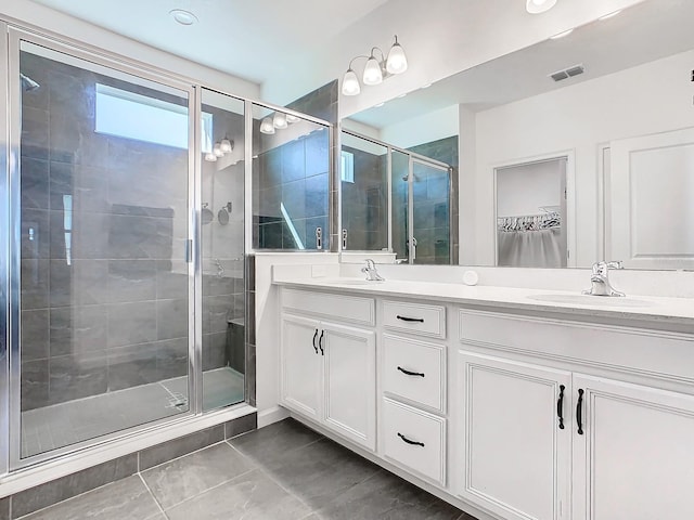 bathroom featuring tile patterned floors, vanity, and walk in shower