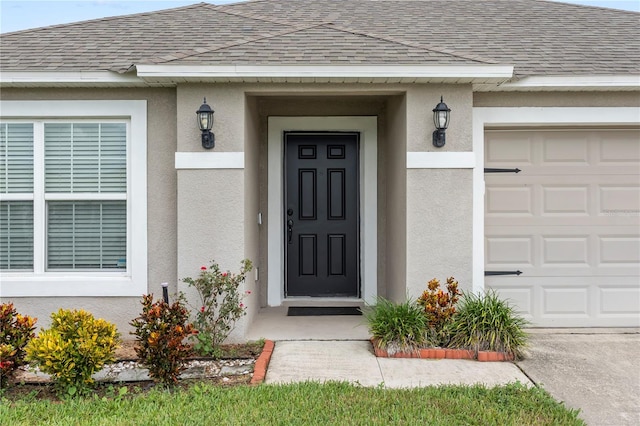 doorway to property with a garage