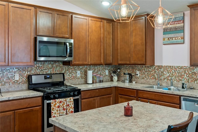 kitchen featuring pendant lighting, stainless steel appliances, lofted ceiling, and decorative backsplash