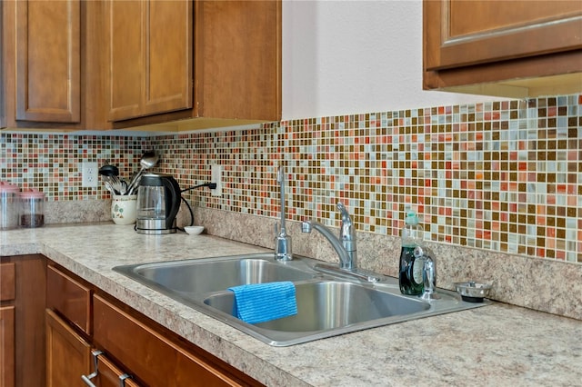 kitchen featuring decorative backsplash and sink