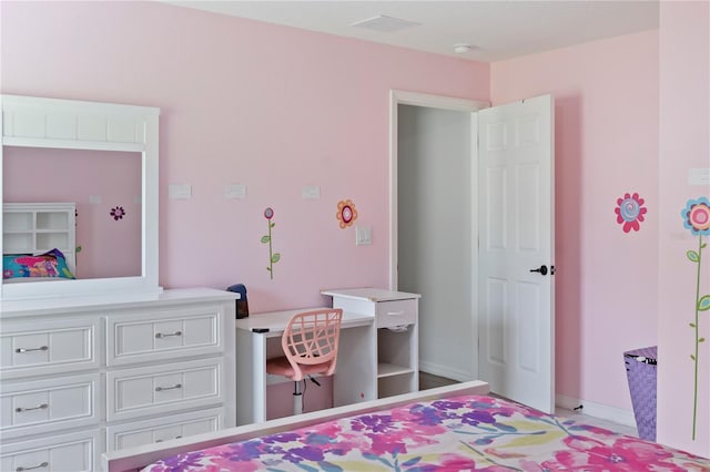 bedroom featuring built in desk