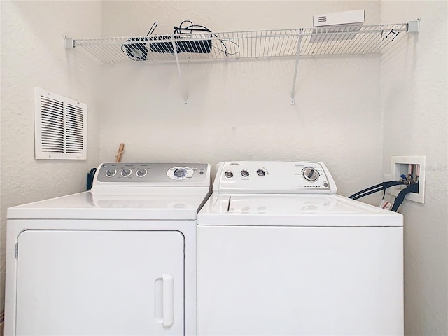 8298 Portofino Dr Unit 202, Davenport, FL 33896 - washroom featuring washer and dryer and a textured wall