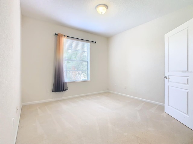 spare room with light carpet