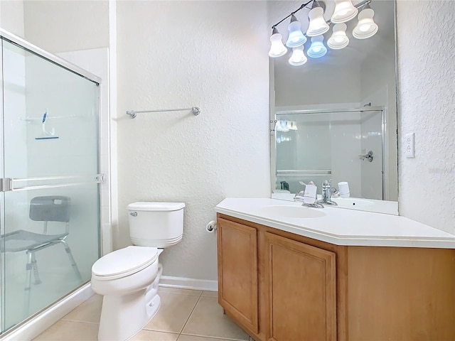 bathroom with vanity, toilet, tile patterned floors, and an enclosed shower