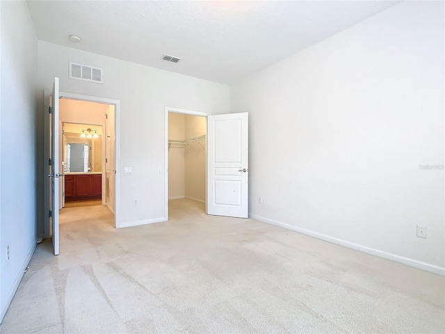 8298 Portofino Dr Unit 202, Davenport, FL 33896 - unfurnished bedroom with light colored carpet, a spacious closet, baseboards, and a closet