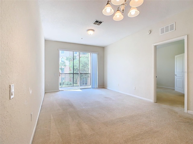 8298 Portofino Dr Unit 202, Davenport, FL 33896 - empty room featuring carpet floors, a chandelier, baseboards, and a textured wall
