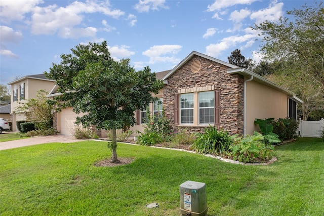 view of front of house with a garage and a front yard