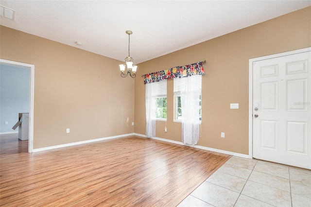 interior space with an inviting chandelier and light hardwood / wood-style flooring