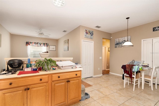 kitchen featuring ceiling fan, light tile patterned flooring, and decorative light fixtures