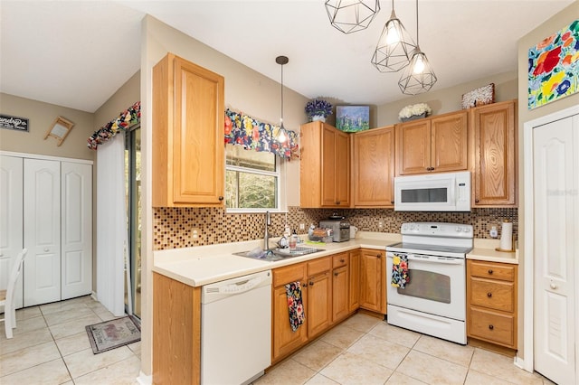 kitchen featuring white appliances, backsplash, sink, light tile patterned floors, and decorative light fixtures