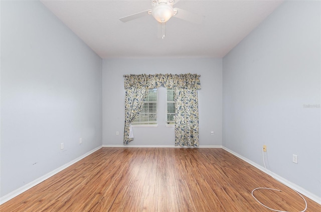 empty room featuring hardwood / wood-style floors and ceiling fan