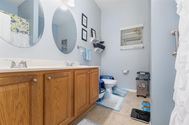 bathroom featuring tile patterned floors, vanity, and toilet