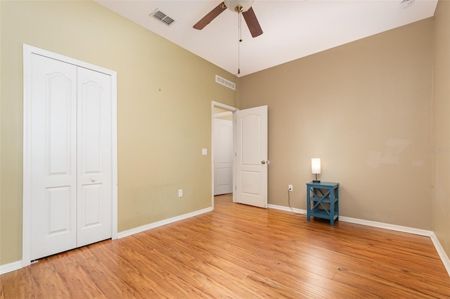 unfurnished bedroom featuring a closet, light hardwood / wood-style floors, and ceiling fan