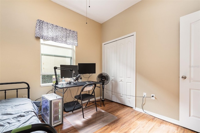 bedroom featuring hardwood / wood-style floors and a closet