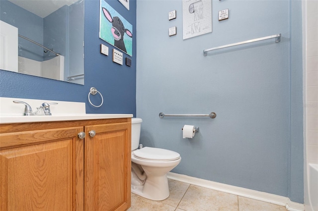 bathroom with toilet, vanity, and tile patterned floors