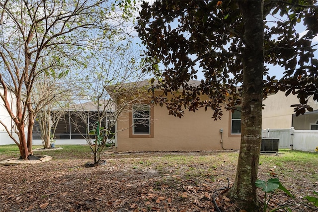 view of side of home with central AC unit