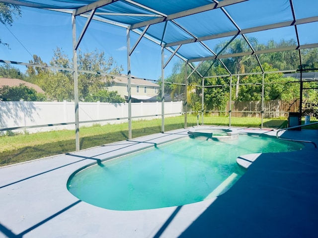 view of swimming pool with glass enclosure and a lawn