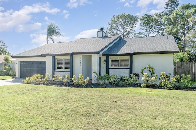 single story home featuring a garage and a front lawn