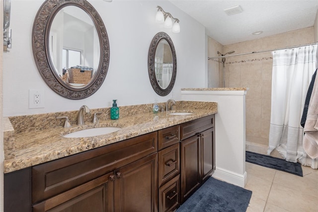 bathroom featuring tile patterned floors, vanity, a textured ceiling, and a shower with shower curtain