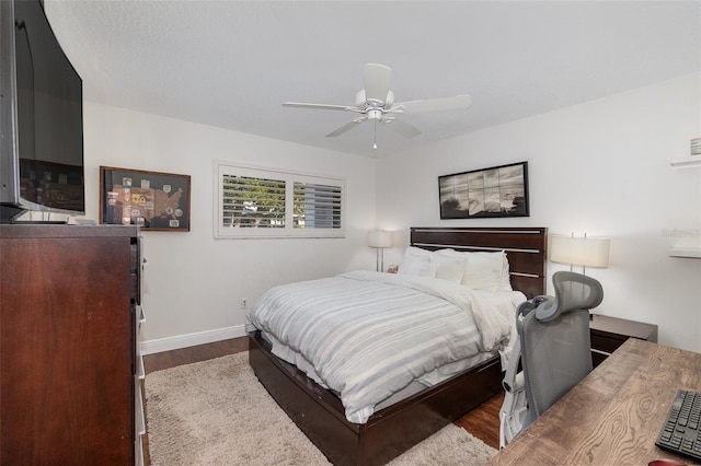 bedroom with ceiling fan and wood-type flooring