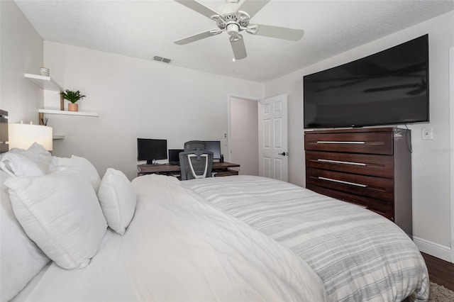 bedroom with ceiling fan and dark hardwood / wood-style flooring