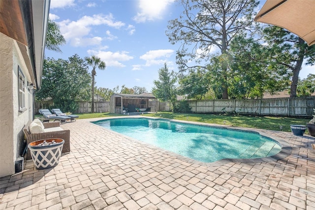 view of swimming pool with a lawn and a patio area