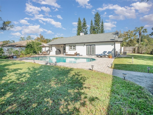 view of pool featuring a yard and a patio