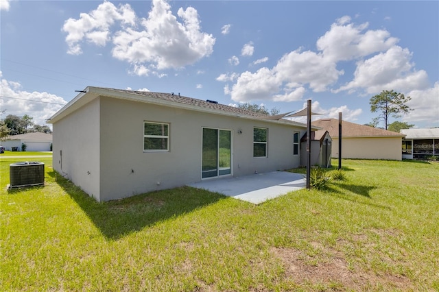 rear view of house with a yard, a patio, and central AC