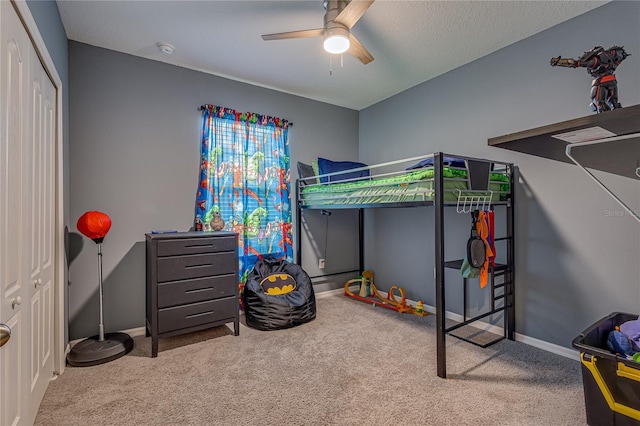 bedroom with ceiling fan, a closet, and carpet