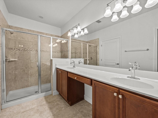 bathroom with tile patterned flooring, vanity, and a shower with shower door