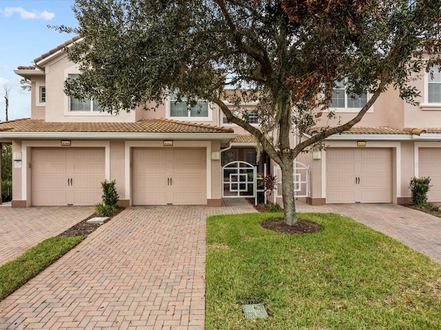 view of front of house with a front yard and a garage