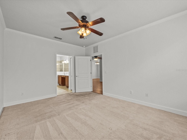 spare room featuring light carpet, ceiling fan, and ornamental molding