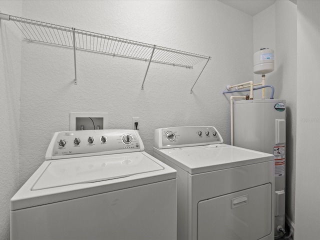 laundry room featuring electric water heater and washer and clothes dryer