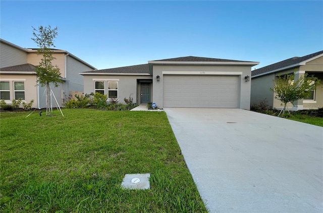 view of front facade with a garage and a front lawn