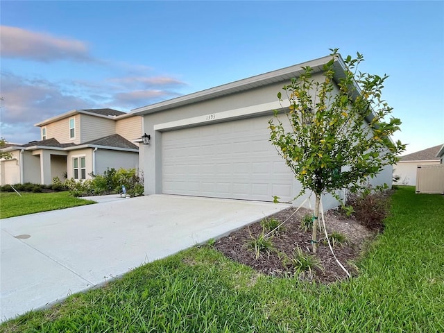 exterior space featuring a lawn and a garage