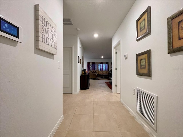 corridor featuring light tile patterned floors