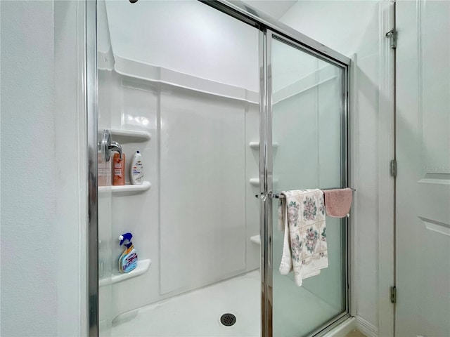 bathroom with a shower with shower door