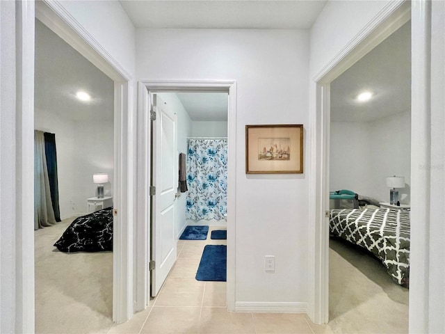 hallway featuring light colored carpet