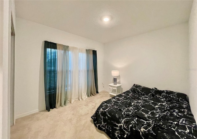 carpeted bedroom featuring a textured ceiling