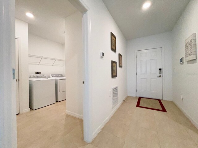 1393 Asher Mason Ave, Kissimmee, FL 34744 - corridor with washer and clothes dryer, light tile patterned floors, recessed lighting, and baseboards