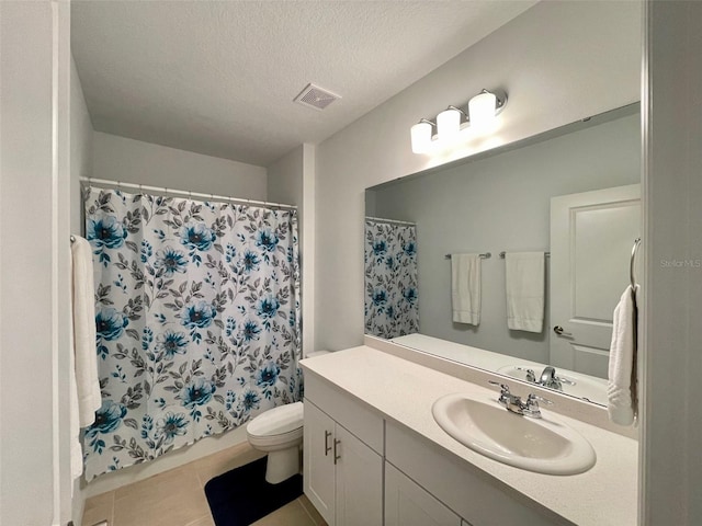 1393 Asher Mason Ave, Kissimmee, FL 34744 - bathroom with toilet, vanity, a textured ceiling, curtained shower, and tile patterned flooring