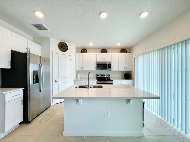 1393 Asher Mason Ave, Kissimmee, FL 34744 - kitchen featuring appliances with stainless steel finishes, a sink, light countertops, a kitchen breakfast bar, and recessed lighting