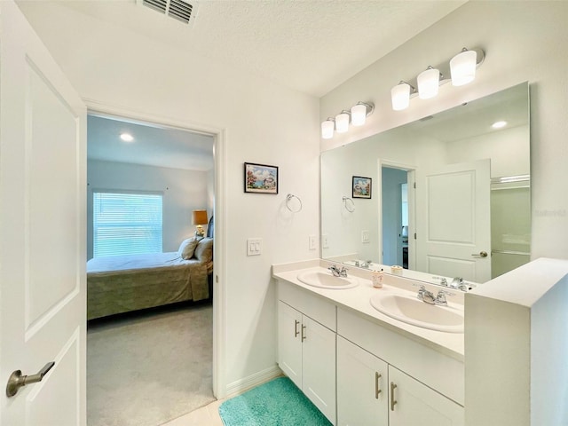 1393 Asher Mason Ave, Kissimmee, FL 34744 - full bath featuring ensuite bathroom, double vanity, baseboards, and a textured ceiling